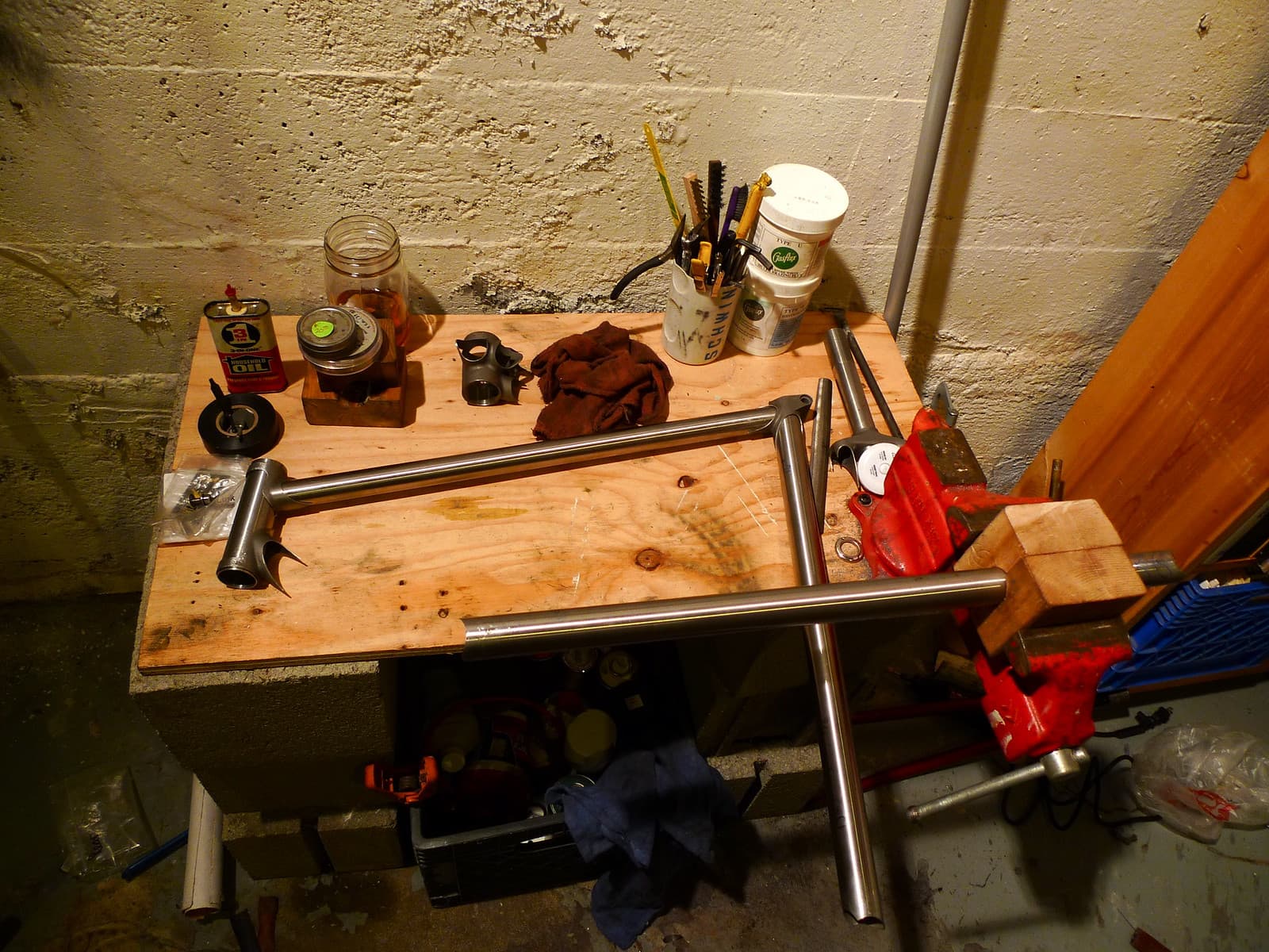 Mitered steel bicycle frame tubes laid out on a workbench before joining